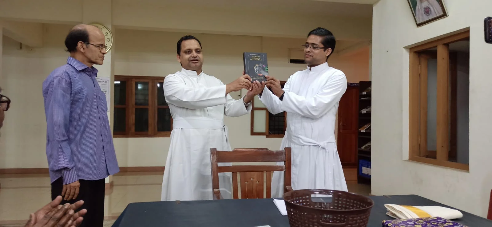 Publishing the book by handing over a printed copy to Fr Dr Davis Panakkal CMI on Jan 08, 2022.